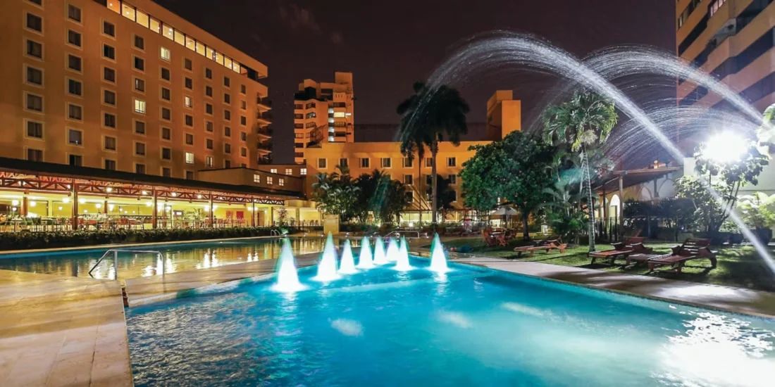 Outdoor pool and terrace at night.